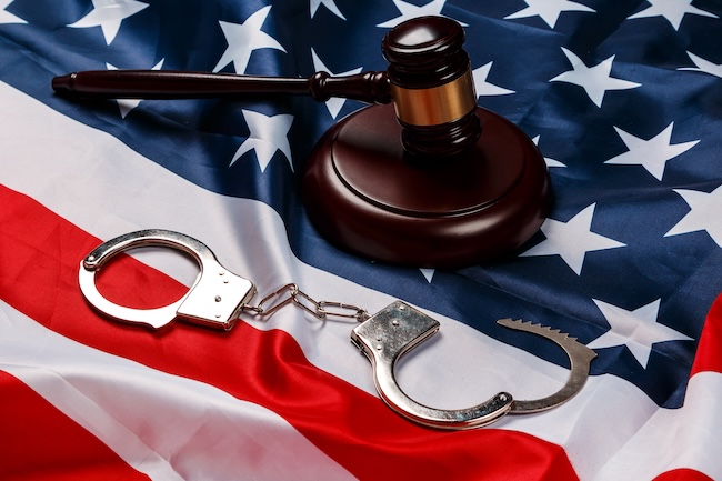 Experienced federal gun trafficking defense attorney reviewing case files in Texas law office