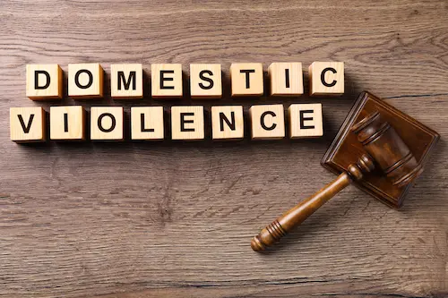 Wooden cubes with words domestic violence and judge gavel