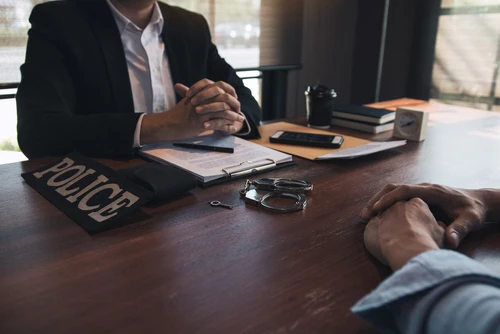 Police questioning a man about a crime in Texas