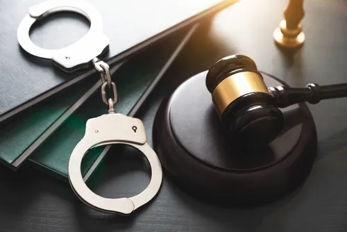 Handcuffs and gavel symbolizing criminal charges and legal defense handled by a College Station sex crimes lawyer.