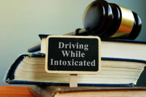Law books and a judge’s gavel labeled ‘Driving While Intoxicated - symbolizing DWI laws and legal defense by an experienced DWI lawyer in The Woodlands TX.