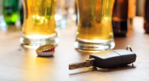 Two alcoholic drinks placed beside a set of car keys representing the dangers of drinking and driving and the importance of hiring a DWI lawyer in The Woodlands TX.