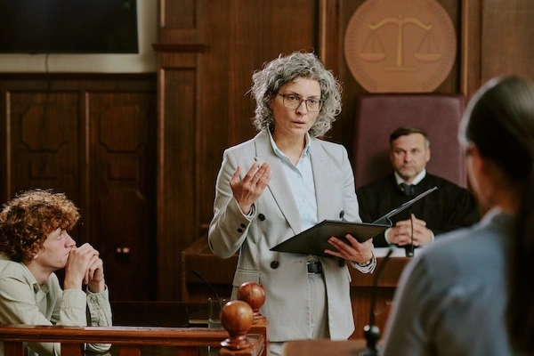 A murder defense lawyer is representing her client in court.